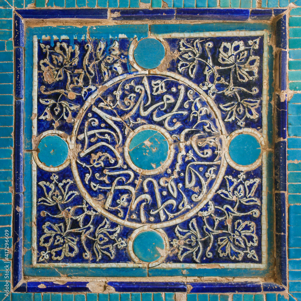 Traditional floral and geometric blue and turquoise tile decoration on facade of islamic mausoleum at Shah-i-Zinda necropolis in UNESCO listed Samarkand, Uzbekistan