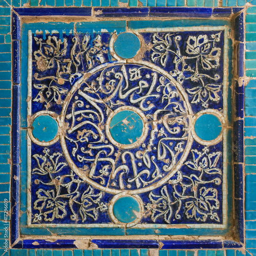 Traditional floral and geometric blue and turquoise tile decoration on facade of islamic mausoleum at Shah-i-Zinda necropolis in UNESCO listed Samarkand, Uzbekistan