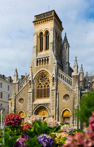 View of neo-Gothic building of Catholic Church of Saint Eugenie in French city of Biarritz in summer day..