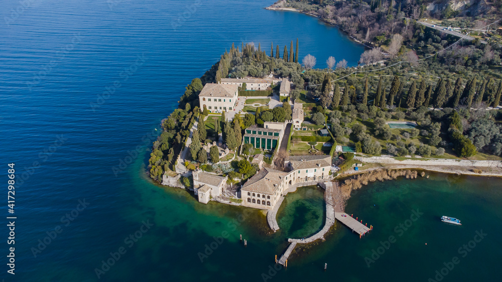 Aerial view of an ancient village Punta San Vigilio on the shores of Lake Garda during a sunny day.