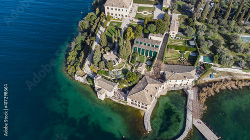 Obraz na płótnie Aerial view of an ancient village Punta San Vigilio on the shores of Lake Garda during a sunny day. w salonie