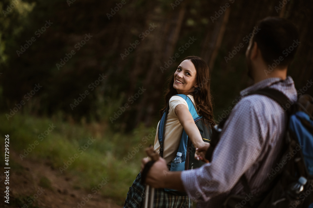 Fototapeta premium Happy couple is hiking in forest.
