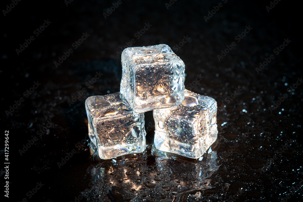 ice cubes reflection on black table background. ice cubes reflection on black table background.