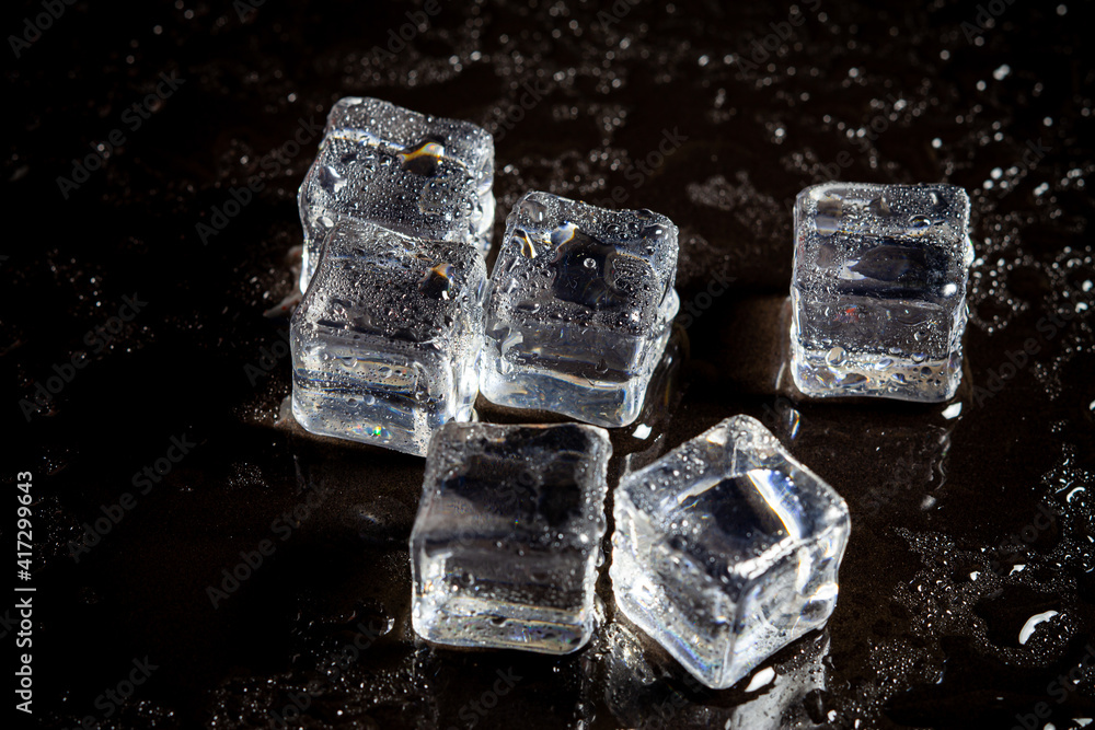 ice cubes reflection on black table background. ice cubes reflection on black table background.