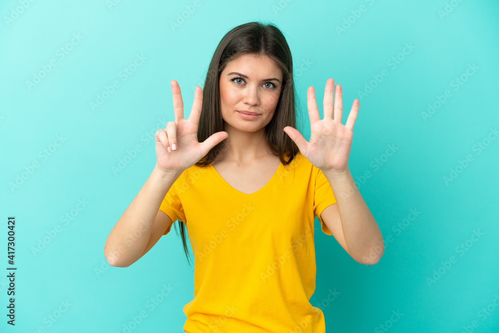 Young caucasian woman isolated on blue background counting eight with fingers Young caucasian woman isolated on blue background counting eight with fingers