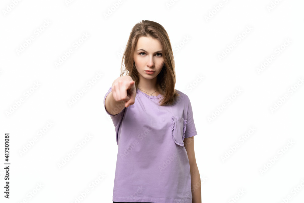 Displeased young woman pointing finger at camera, blaming you, isolated on white background Displeased young woman pointing finger at camera, blaming you, isolated on white background