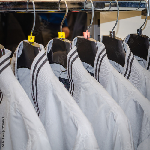 Sports jackets hang on hangers.
