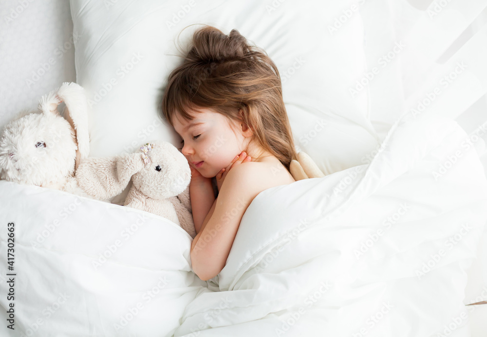 Little girl sleeping sweetly in a white bed Little girl sleeping sweetly in a white bed