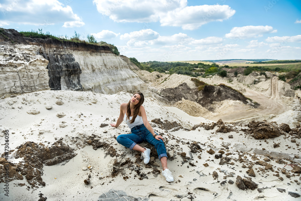 charming young girl travels in a sandy canyon quarry