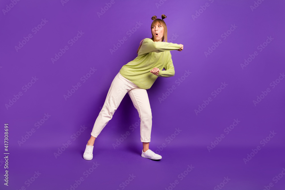 Photo of funky adorable young lady wear green sweater dancing looking empty space copyspace isolated violet color background