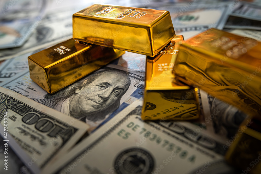 Gold bars on 100 US Dollar note as background Gold bars on 100 US Dollar note as background