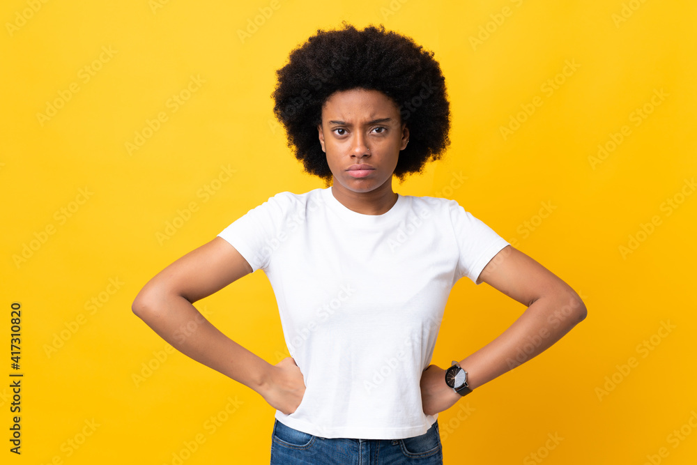 Young African American woman isolated on yellow background angry Young African American woman isolated on yellow background angry