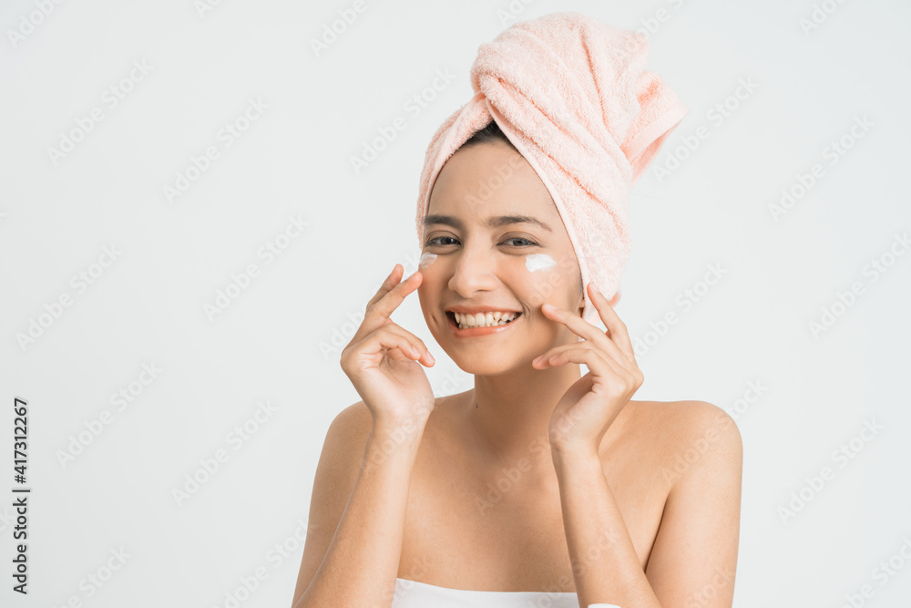 attractive and beauty asian woman put cosmetic cream on her face over white background attractive and beauty asian woman put cosmetic cream on her face over white background