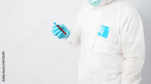 Fototapeta Naklejka Na Ścianę i Meble -  Male model with PPE suite and Hand with glove is holding blood collection tube on white background.