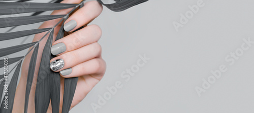 Photo Female hand with gray nail design
