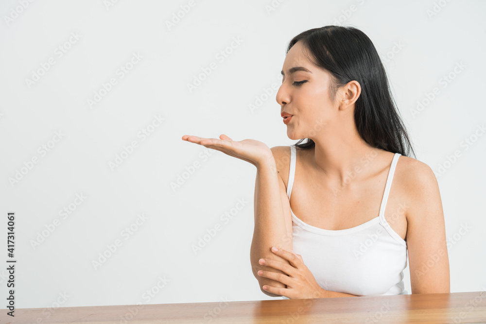 attractive young asian woman blowing a kiss on white background attractive young asian woman blowing a kiss on white background