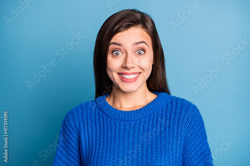 Portrait of young lovely pretty charming positive happy excited crazy girl smiling wear sweater isolated on blue color background