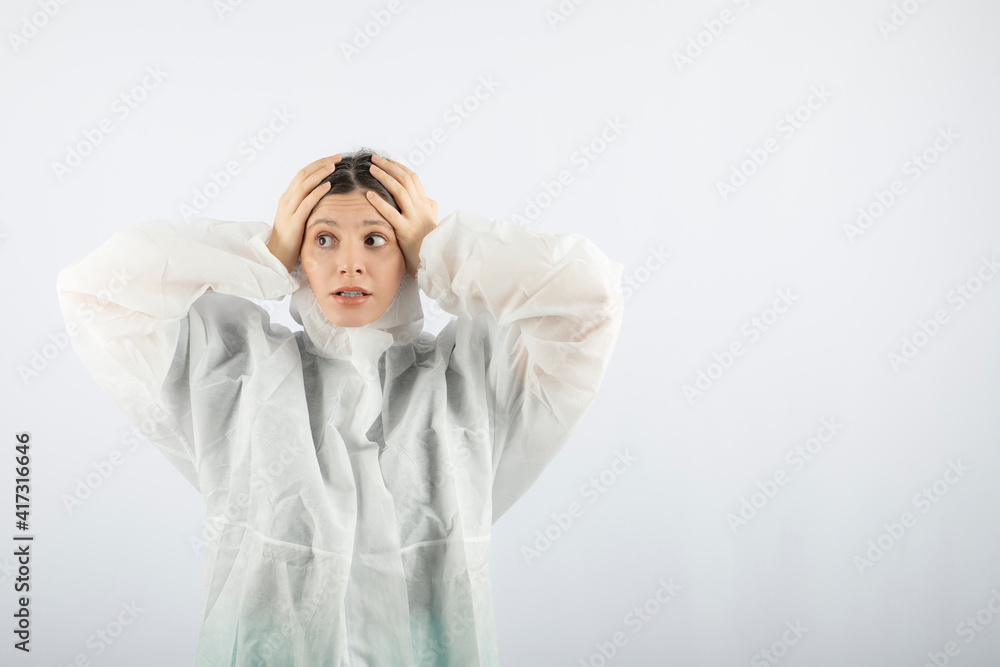 Portrait of young female doctor scientist in defensive lab coat posing Portrait of young female doctor scientist in defensive lab coat posing