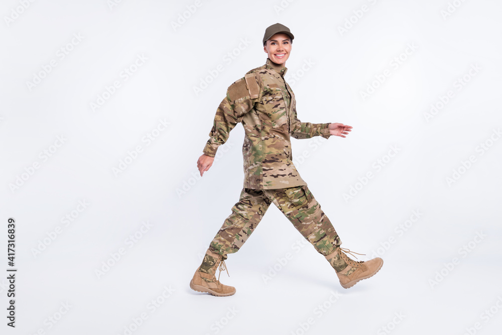 Full body profile photo of charming positive person walking look camera isolated on white color background Full body profile photo of charming positive person walking look camera isolated on white color background
