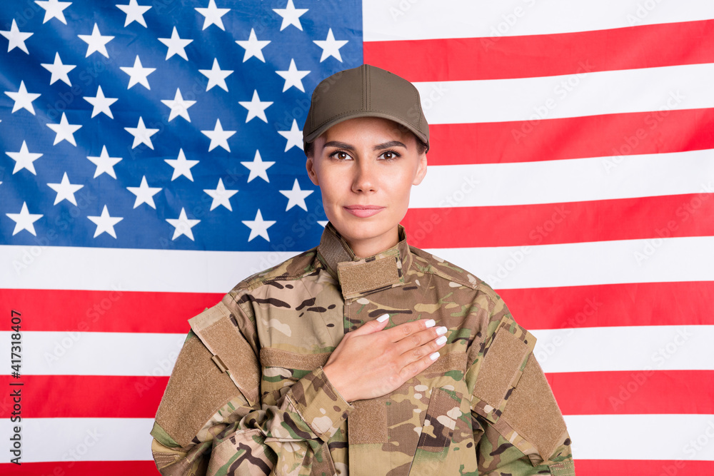 Portrait of attractive positive lady arm palm on heart look camera isolated on usa national flag background Portrait of attractive positive lady arm palm on heart look camera isolated on usa national flag background