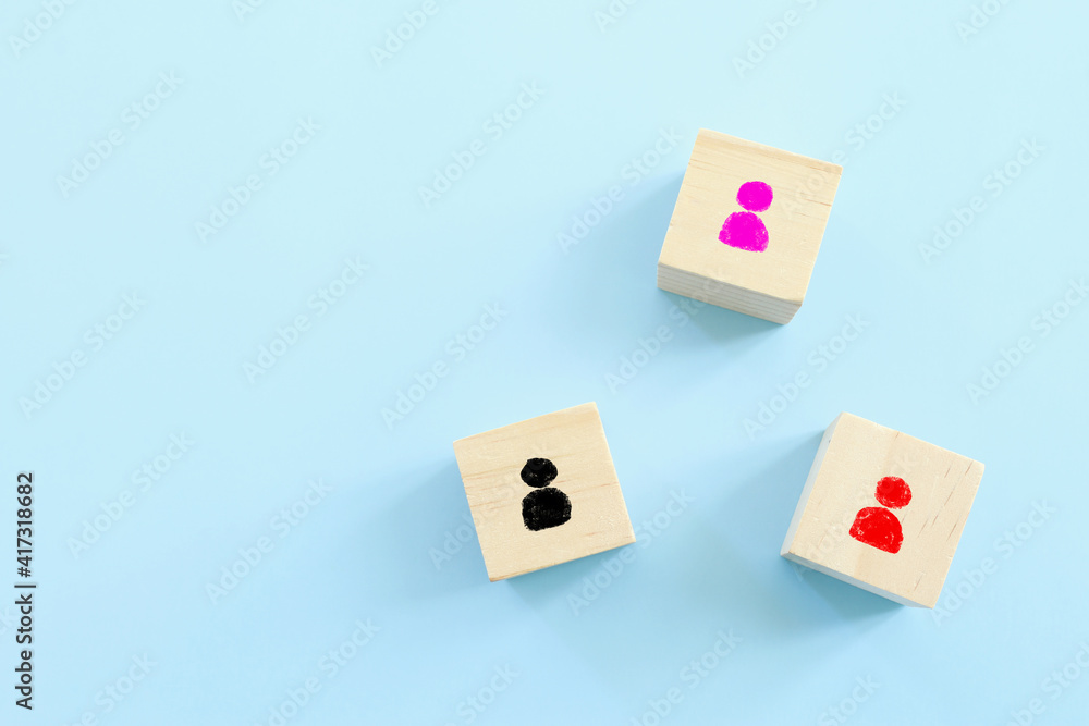 wooden blocks with people icon over blue background, building a strong team, human resources and management concept wooden blocks with people icon over blue background, building a strong team, human resources and management concept