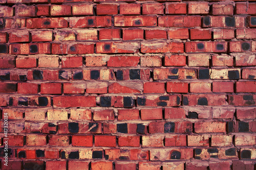 Messy red brick wall as a background with space for design