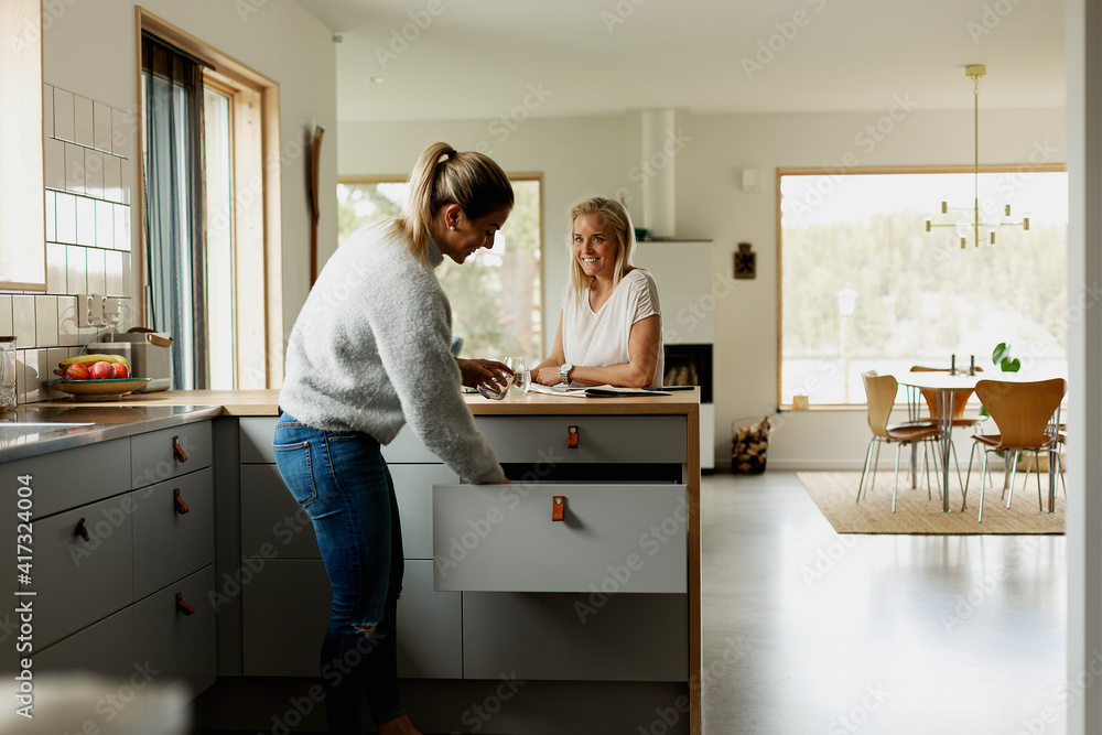 Two women at kitchen counter Two women at kitchen counter