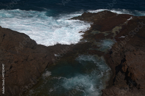 Gran Canaria, north coast, area around Punta Sardina cape, powerful foamy ocean waves breaking along the shore 