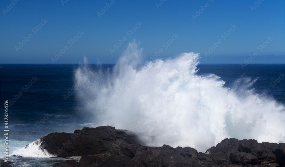 Gran Canaria, north coast, area around Punta Sardina cape, powerful foamy ocean waves breaking along the shore
