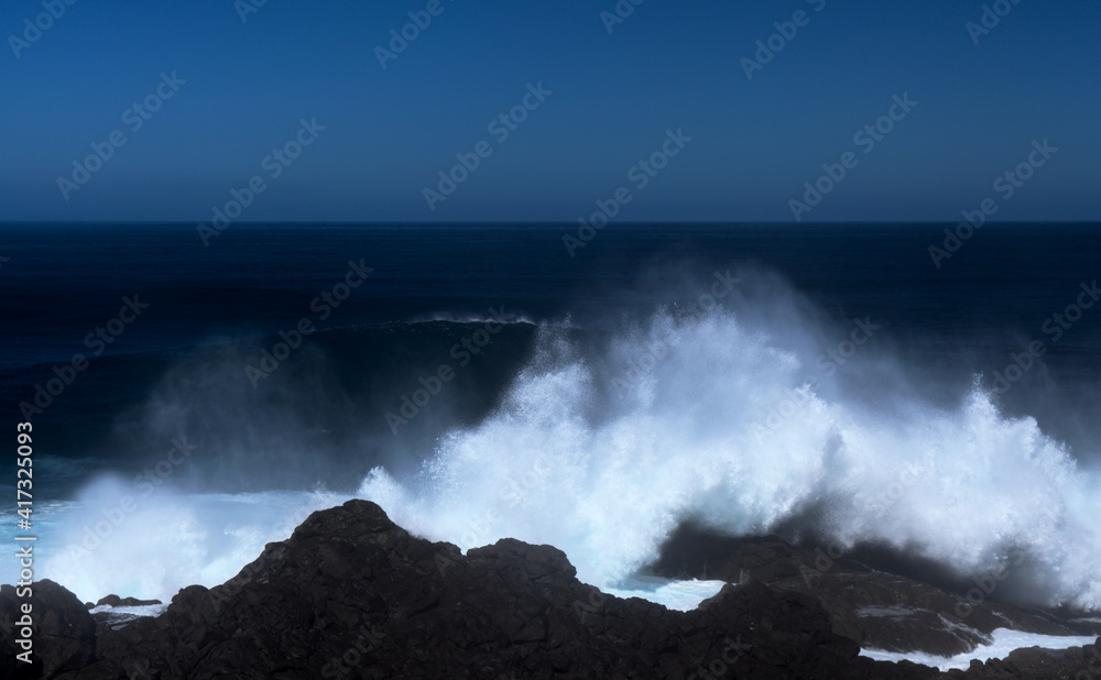 Gran Canaria, north coast, area around Punta Sardina cape, powerful foamy ocean waves breaking along the shore
