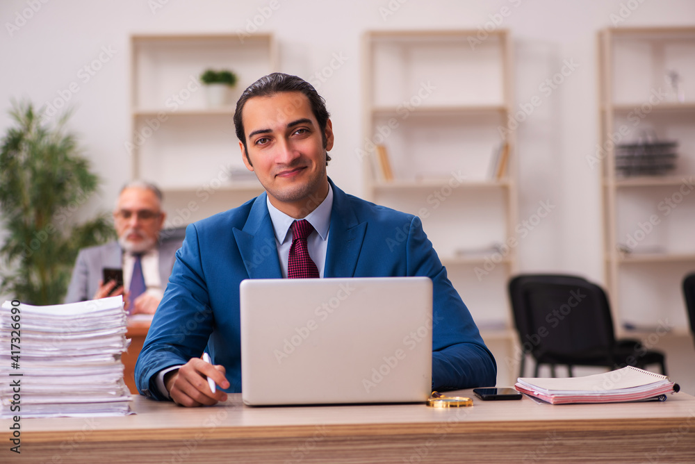 Two employees working in the office Two employees working in the office