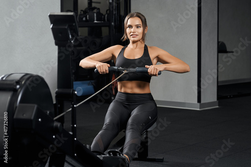 Perfect sports woman doing exercise in gym.