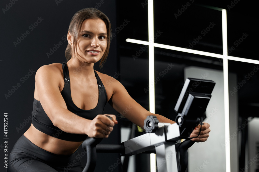 Young woman doing exercise in gym.