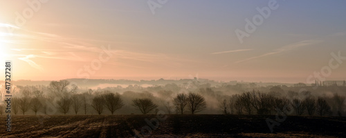 Tree lined landscape at sunrise looking towards Milton Earnest from Sharnbrook Bedfordshire.. photo