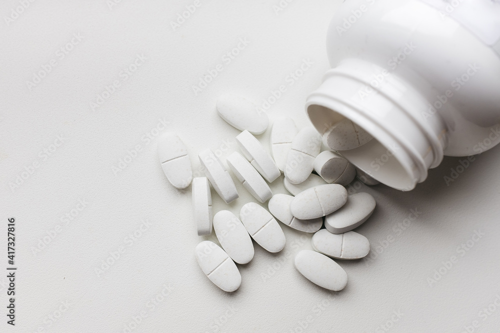 white pills on white background white pills on white background