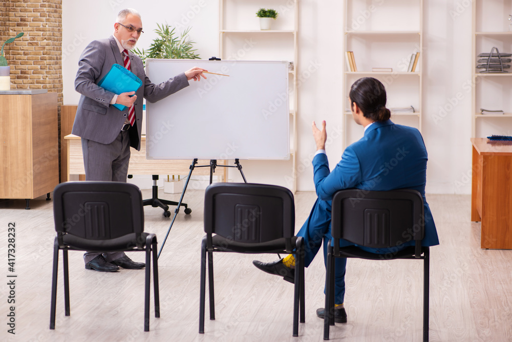 Two male employees in business meeting concept Two male employees in business meeting concept