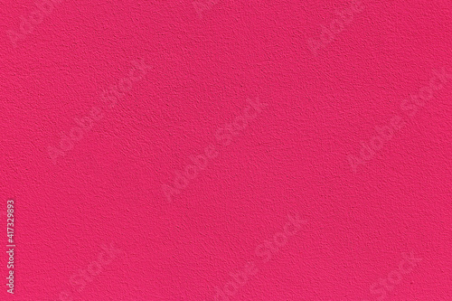 Red surface of uneven modern plaster with a pink gradient. Template for design