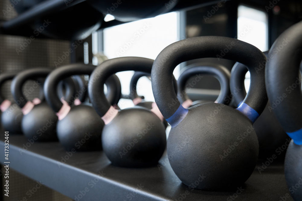 Black kettlebells in modern gym. Black kettlebells in modern gym.
