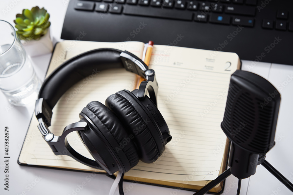 Microphone and headphones on the table, top view. Radio podcast workplace Microphone and headphones on the table, top view. Radio podcast workplace