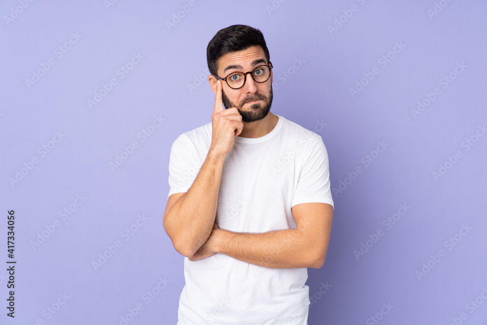 Caucasian handsome man over isolated background thinking an idea Caucasian handsome man over isolated background thinking an idea