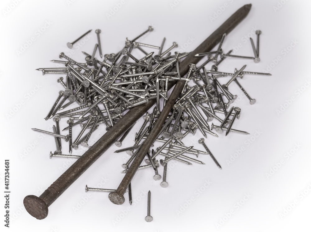 Big and medium nails among a pile of small nails