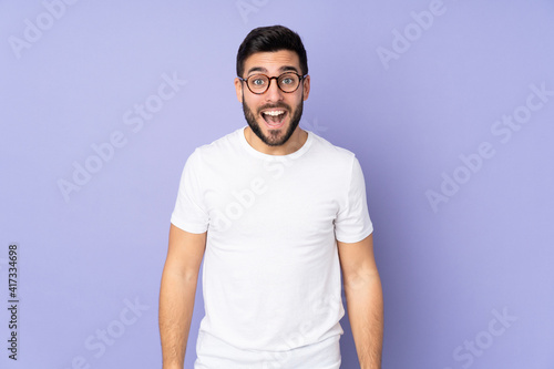 Caucasian handsome man over isolated background with surprise facial expression