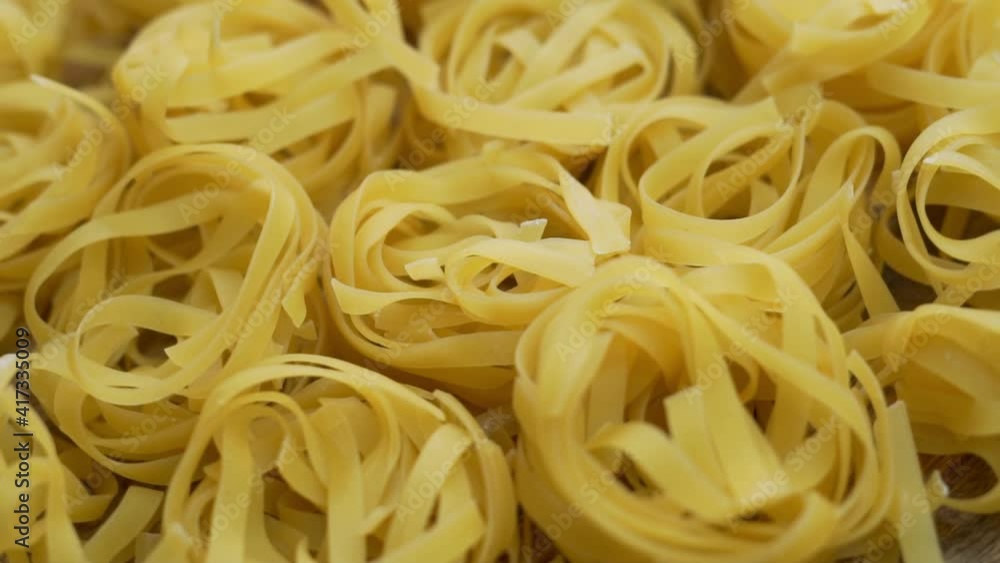 High-Quality Delicious Italian Spaghetti in the Form of Nests of Durum Wheat, Close-up, Isolated, Rotation. Background of the Beans, Italian Pasta Uncooked High-Quality Delicious Italian Spaghetti in the Form of Nests of Durum Wheat, Close-up, Isolated, Rotation. Background of the Beans, Italian Pasta Uncooked