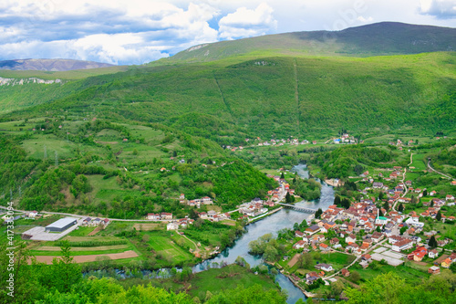 The magnificent panoramic view of the mountain valley of Una river and traditional village Kulen Vakuf from the top of ruined castle Ostrovica photo