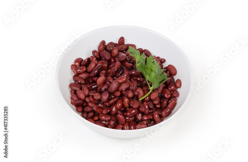 Boiled red kidney beans in white bowl on white background