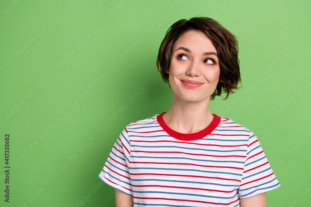 Fototapeta premium Photo of pretty positive lady look interested empty space imagine thinking isolated on green color background