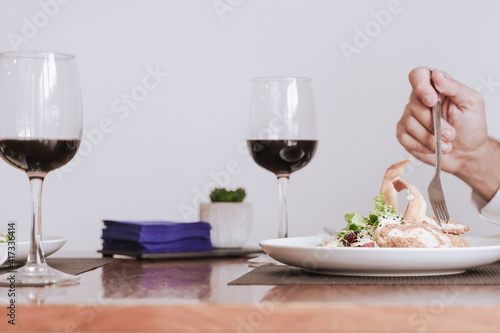 Portrait of a hand with food and wine. Food, drink and romantic concept.