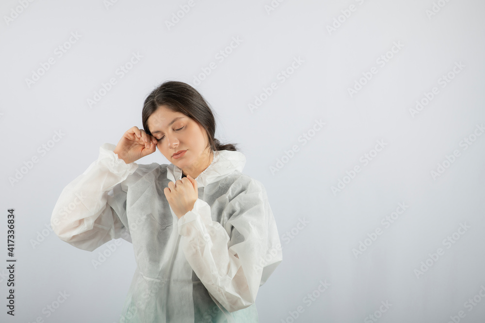 Portrait of young female doctor scientist in defensive lab coat posing Portrait of young female doctor scientist in defensive lab coat posing