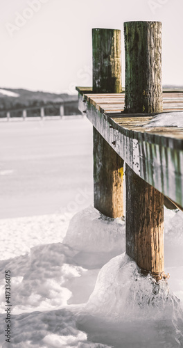 Wallpaper Mural Old worn wooden pier locked on thick sea ice on a clear cold winters day. Shallow depth of field. Torontodigital.ca