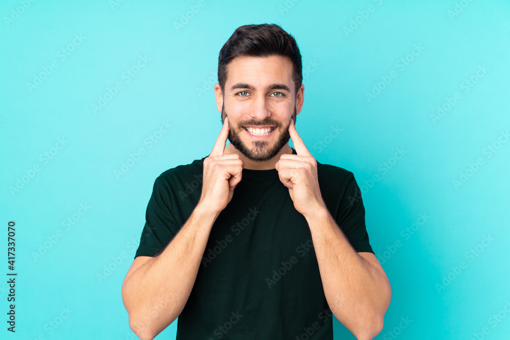 Caucasian handsome man isolated on blue background smiling with a happy and pleasant expression Caucasian handsome man isolated on blue background smiling with a happy and pleasant expression